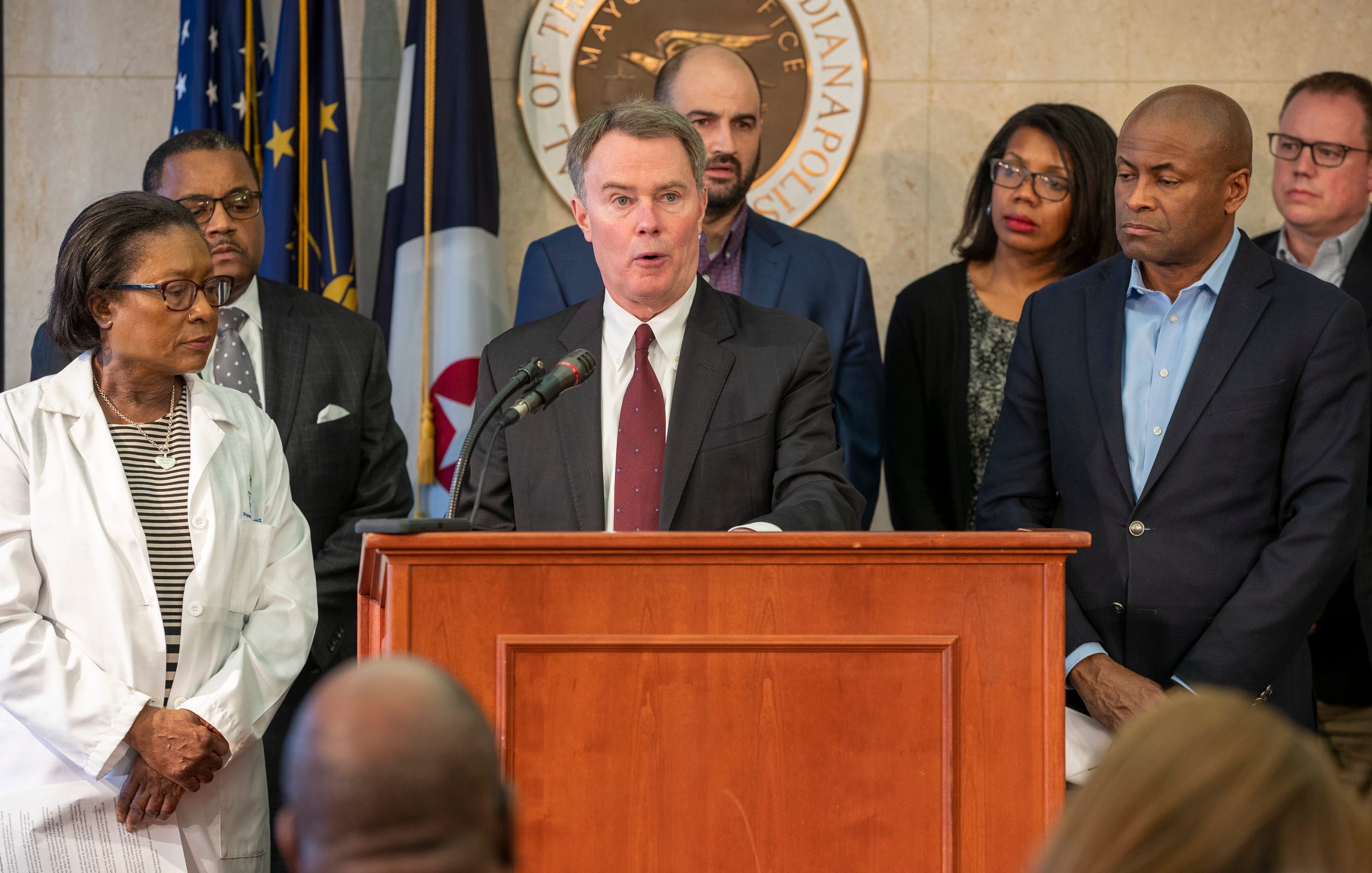 Indianapolis Mayor Joe Hogsett, surrounded by educators, medical personnel, and other city officials, talks about the decision to close county schools amid fears about COVID-19,  Indianapolis, Thursday, March 12, 2020. The move is a preemptive one, and currently no students or faculty have the Coronavirus. 