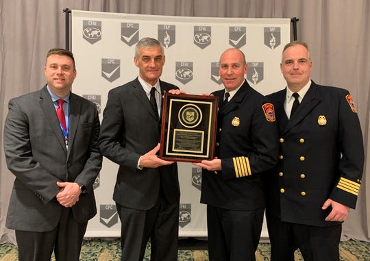 Left to right are, Joshua Meier, Canton Director of Public Safety; Steve Dongworth, CFAI CommissionChairperson; Chris Stoecklein, Canton Deputy Director of Fire; and Jamie Strassner, Canton Deputy Fire Chief