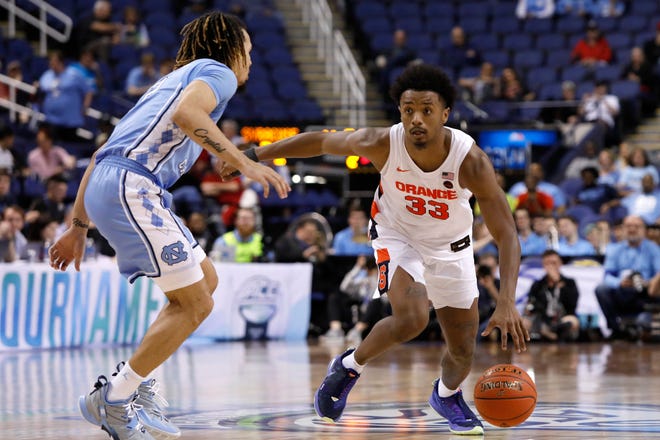 North Carolina guard Cole Anthony (2) guards Syracuse forward Elijah Hughes (33) during the second half of an NCAA college basketball game at the Atlantic Coast Conference tournament in Greensboro, N.C., Wednesday, March 11, 2020. Hughes scored 27 points in Syracuse's 81-53 victory.