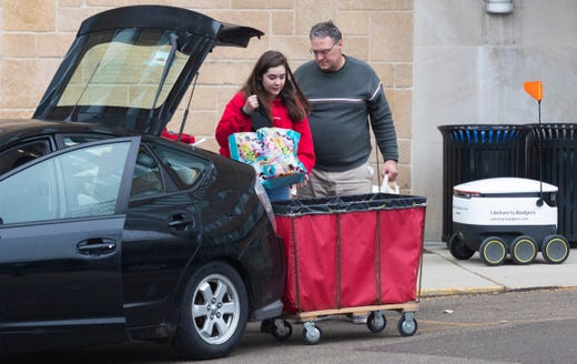 A woman moves out of Chadbourne Hall Thursday, March 12, 2020 on the campus of UW-Madison in Madison, Wis. The university is one of multiple Wisconsin universities on Wednesday took dramatic steps to ward off or curb the spread of the COVID-19 outbreak, everything from moving courses online to canceling university-sponsored travel and events to extending spring break.