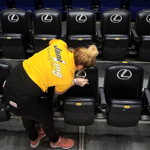 A worker cleans the seats after the announcement o