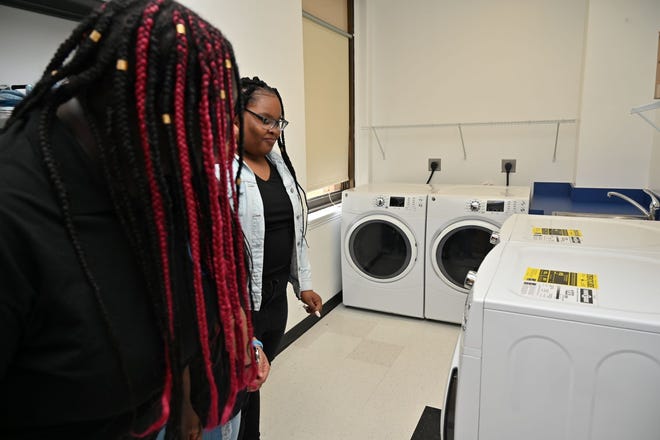 Students marvel at the new front-loading washers and dryers in the Asbury Park High School Legacy Center.