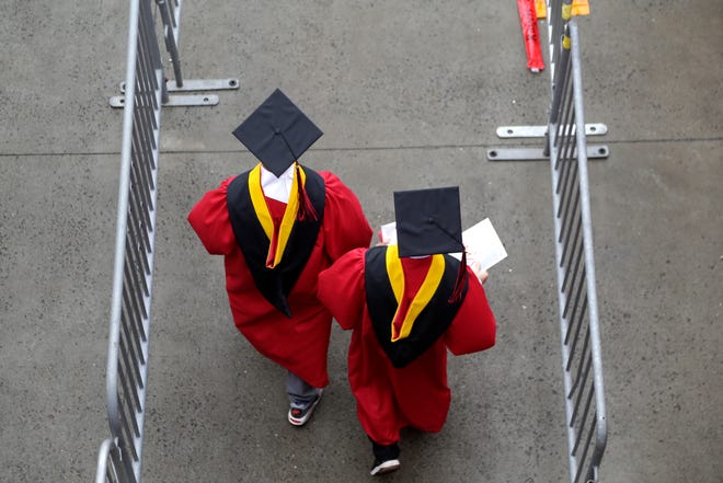 FILE - In this May 13, 2018, file photo, new graduates walk into the High Point Solutions Stadium before the start of the Rutgers University graduation ceremony in Piscataway Township, N.J.