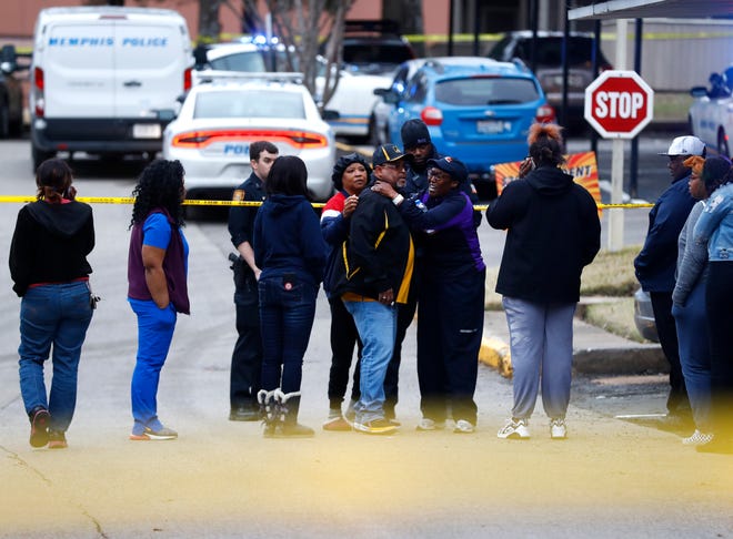 Family members gather outside home at the Canterbury Woods Apartments on Gallan Drive where a 9-year-old was shot and killed on Friday, March 13, 2020.
