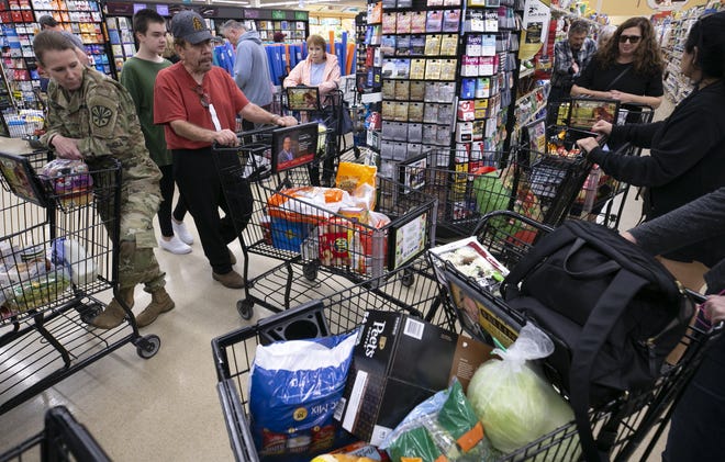Long lines to check out at a Safeway grocery store in Phoenix on March 12, 2020.