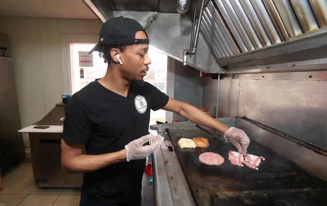 Zaaqi (Zoc) Johnson in his gourmet burger restaurant, Zoc's Gourmet, on Chili Avenue. Business has slowed amid the coronavirus outbreak.
