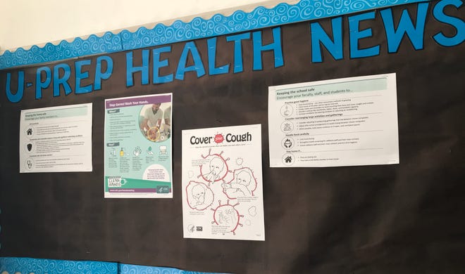 A U-Prep health news bulletin board gives students tips about hygiene and how to curb the spread of germs.