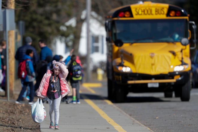 A student leaves school at the end of the day on Friday, March 13, 2020, at Washington Elementary School in Stevens Point, Wis. The Stevens Point Area School District announced Friday that it is canceling school through March 29 due to concerns of COVID-19.Tork Mason/USA TODAY NETWORK-Wisconsin