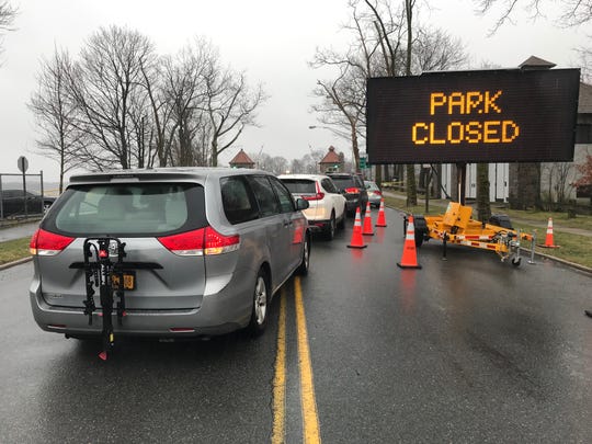 People who have appointments to get tested for COVID-19 line up before the bridge to get onto Glen Island Park in New Rochelle on March 13, 2020. A drive-thru coronavirus testing site has been set up at the county park.