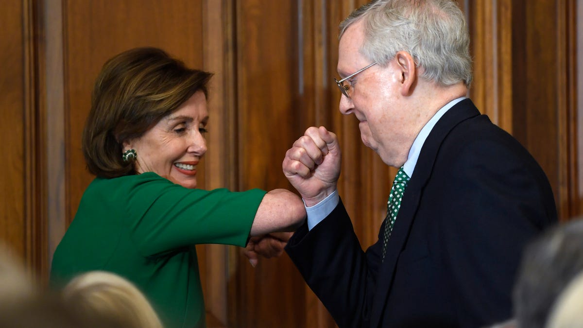 House Speaker Nancy Pelosi of Calif., left, and Senate Majority Leader Mitch McConnell of Ky., right, bump elbows as they attend a lunch with Irish Prime Minister Leo Varadkar on Capitol Hill in Washington, Thursday, March 12, 2020.