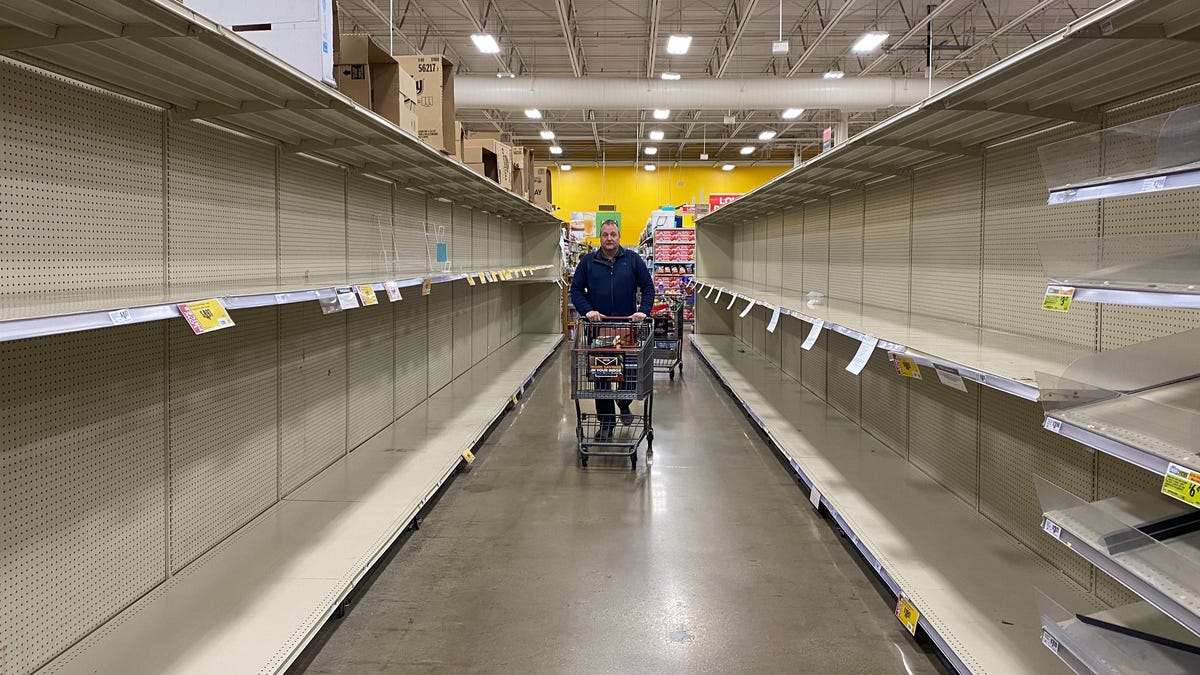 Customers at grocery chain HEB in Austin look for products among increasingly empty shelves as the city responds to concerns of the spread of the new coronavirus and COVID-19 on March 13, 2020.