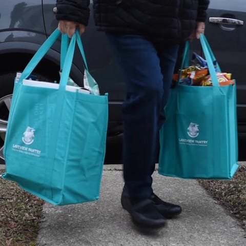 Volunteers deliver meals to the homes of quarantin