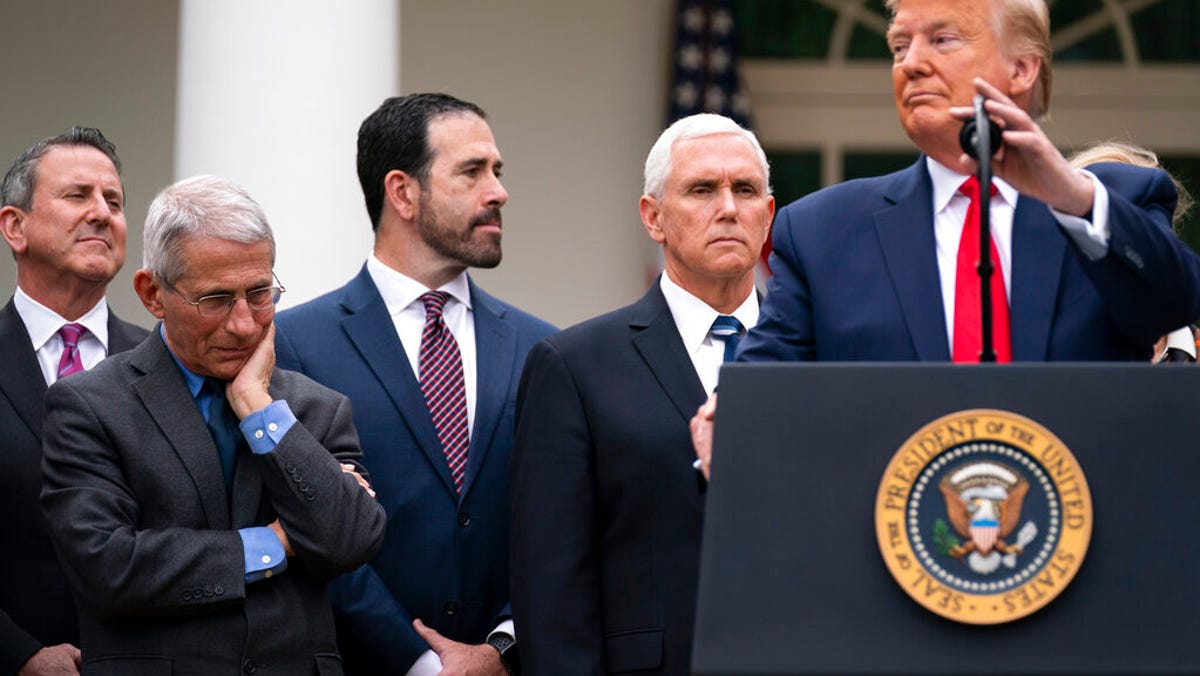 Dr. Anthony Fauci, director of the National Institute of Allergy and Infectious Diseases, listens as President Donald Trump speaks during a news conference on the coronavirus in the Rose Garden at the White House, Friday, March 13, 2020, in Washington.