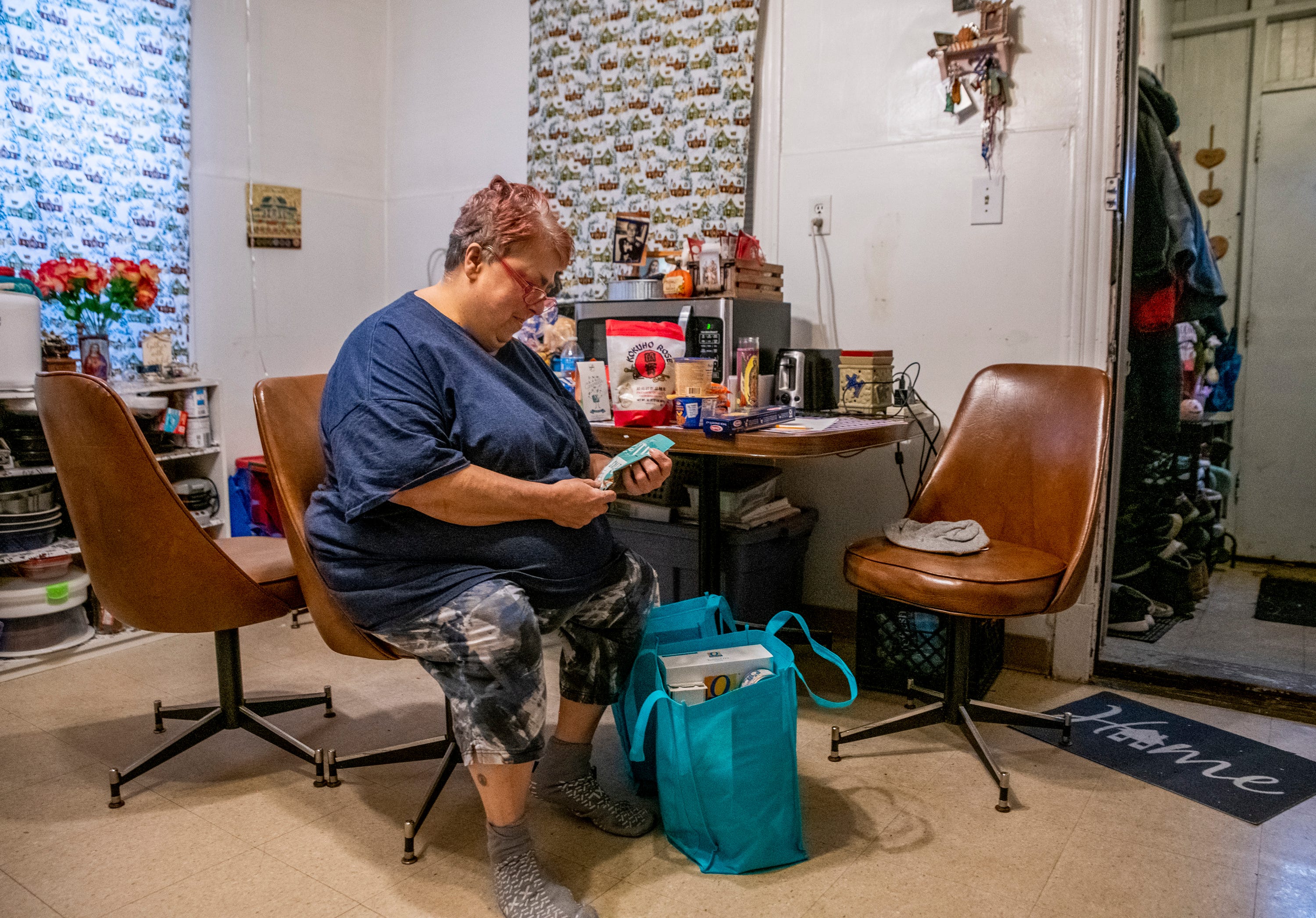 Rose McDonough sorts through donations delivered to her door in March in Chicago. Her son Michael McDonough Jr. is a student at Vaughn Occupational High School, the first Chicago school to shut down because of the pandemic.