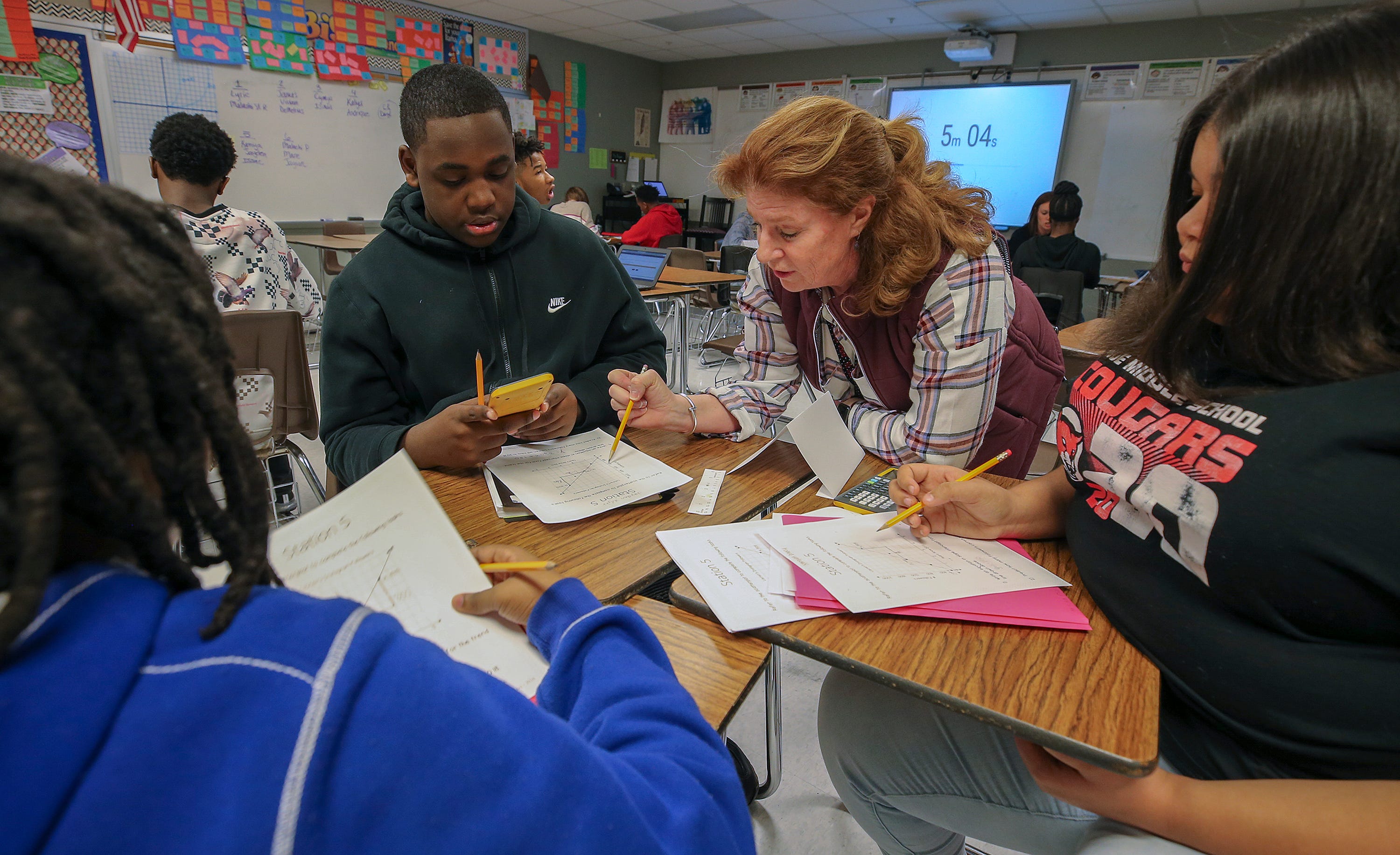Teacher Shellie Lipka works with Issac Lacy, Jayden Wright and Kamiya Dailey in a class at Noe Middle School on March 6, 2020.