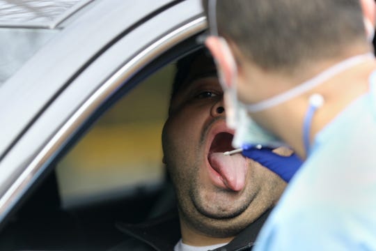A man (who gave permission to be photographed, but wished not to give his name) is shown as he prepares to get swabbed at a coronavirus testing drive-through, at Riverside Medical Group, in Secaucus. Sunday, March 15, 2020