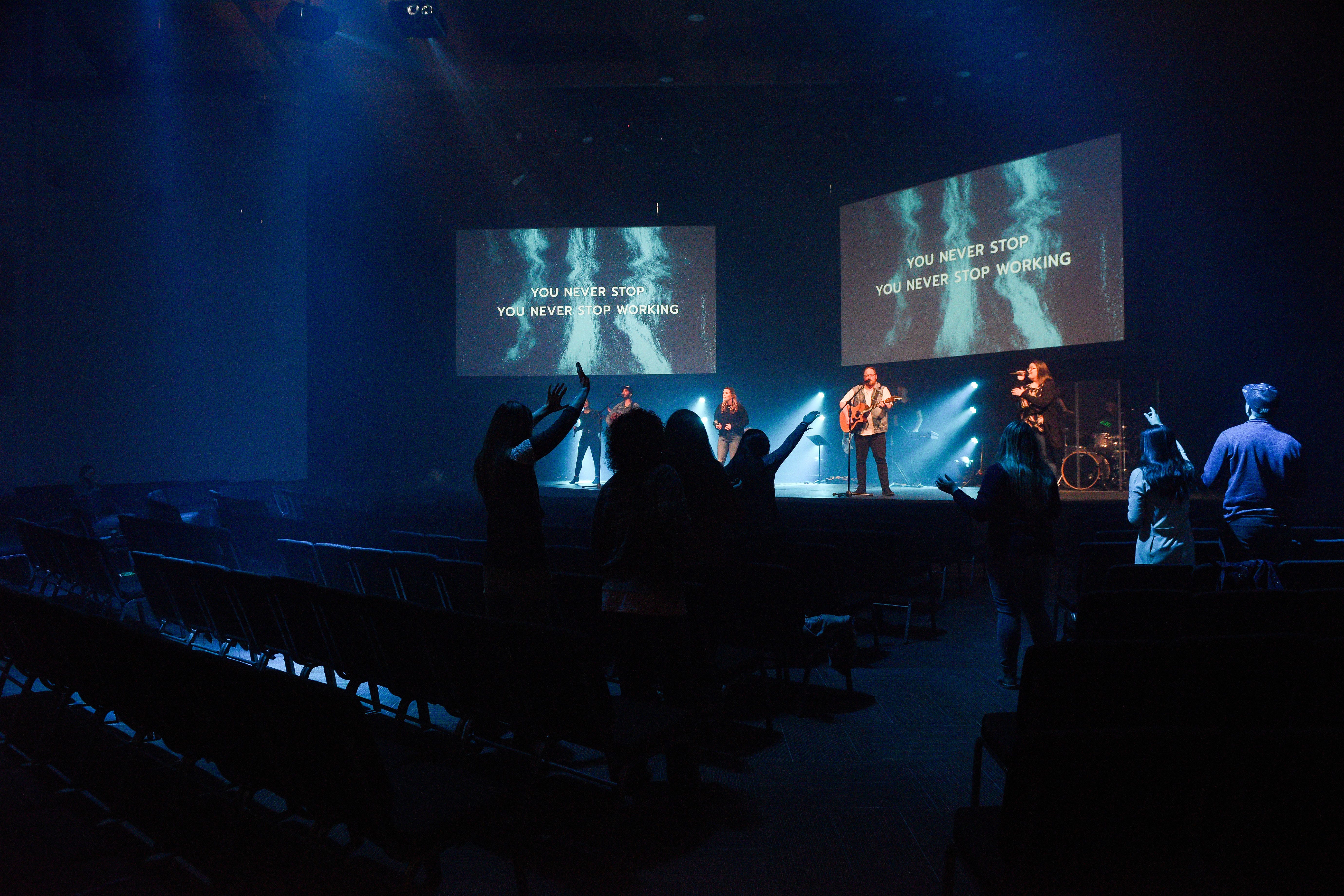 A handful of Embrace Church staff members stand and worship with the music team performs during a service without parishioners on Sunday, March 15, in Sioux Falls. The services are live-streamed instead to mitigate concerns about the coronavirus.