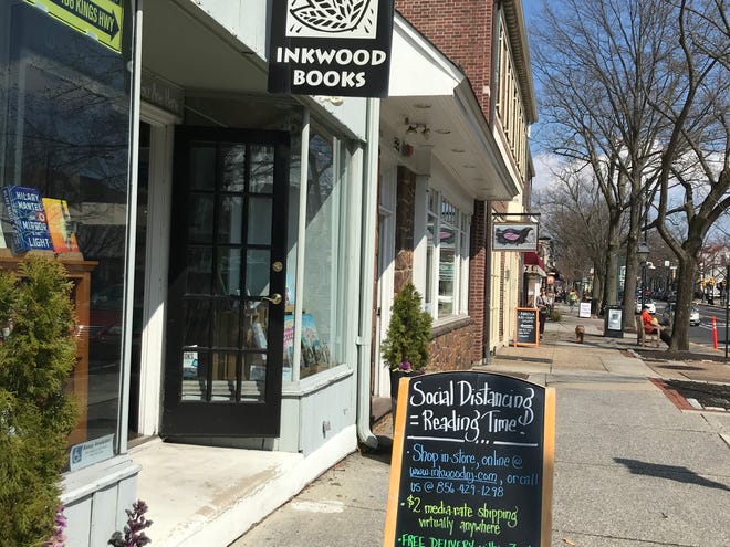 A sign of the times outside Inkwood Books in Haddonfield offers the store's own solutions to social distancing: delivery options and activities for kids to take home.