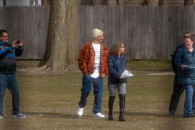 Newlyweds April and Dormon Page of Roseville, Michigan, walk through Geary Park in Ferndale, Michigan, on Monday, March 16, 2020, shortly after getting married.