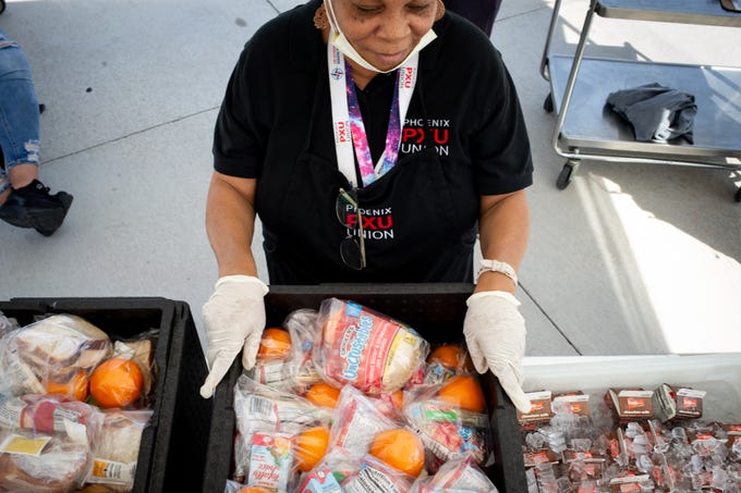 Tauheedah Aleem waits for students to pick up lunch, March 16, 2020 at South Mountain High School in Phoenix.