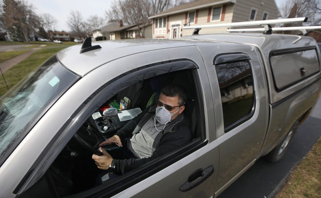 Victor Millan sits in his truck outside his Greece home Monday, March 16, 2020. Millan slept in his truck last night, after being told by Monroe County he needs to quarantine because he may have had contact at his job with a coronavirus carrier. Millan has an auto-immune child in his home so doesn’t feel safe in there. 