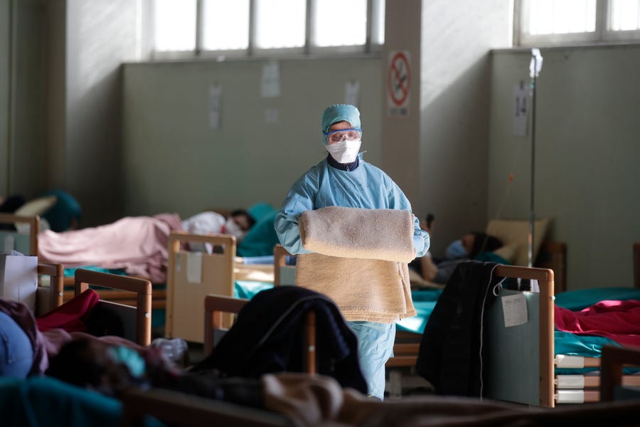 Medical staff work at one of the emergency structures that were set up to ease procedures at the Brescia hospital in northern Italy, March 16, 2020.