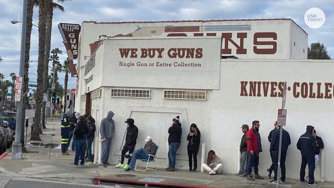 People line up at gun stores to stock up