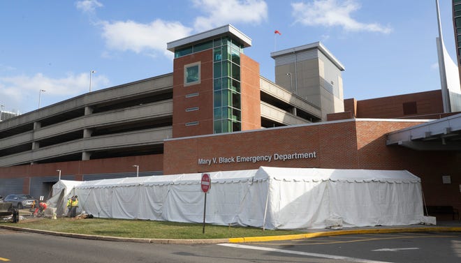 A temporary tent is assembled outside the Mary V. Black Emergency Department of the Jersey Shore University Medical Center in Neptune, NJ on March 17, 2020.