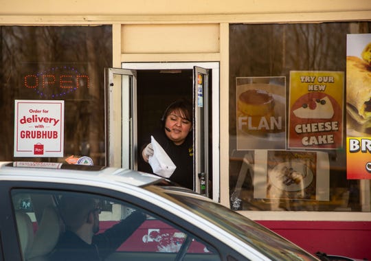 Miriam Erbantes works the drive-thru window at Abelardo's Mexican Restaurant in Des Moines Tuesday, March 17, 2020.