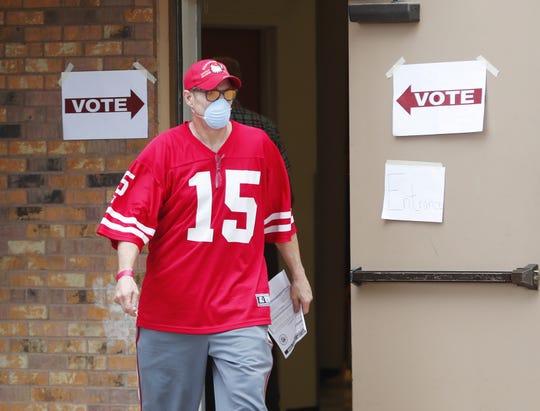 Richard Kimmel walks out of a polling center after casting his vote in the Arizona Democratic primary at the Pyle Adult Recreation Center in Tempe on March 17, 2020.