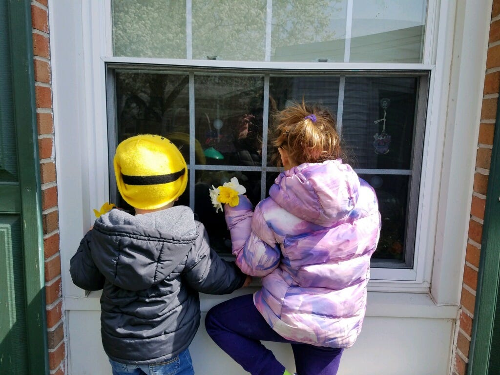 Livie and Collins Marvel visit their great-grandmother through a window at the Milford Manor nursing home. Visitors haven't been able to enter nursing homes and assisted-care facilities throughout the state for several days due to the COVID-19 pandemic.