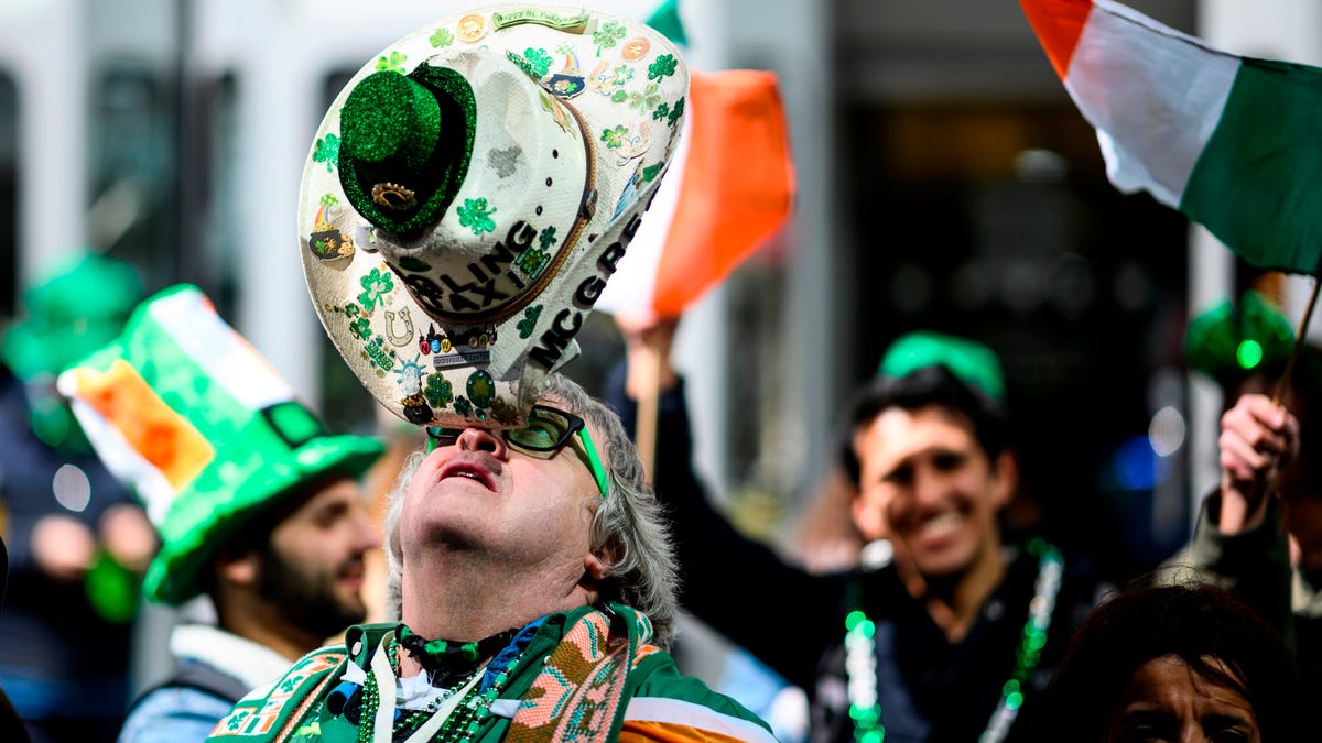 In this file photo taken on March 16, 2019 a man balances his hat during the annual New York City St. Patrick's Day Parade on March 16, 2019. The New York City St. Patricks Day Parade has been postponed for the first time in its 258-year history because of coronavirus concerns.