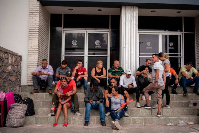 Cubans are pictured waiting outside of the Centro de Attention Integral de Migrantes office to register for their numbers to cross into the United States, in Ciudad Juarez, Chihuahua State, on May 20, 2019.