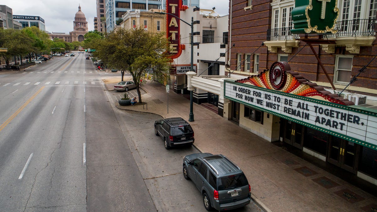 Congress Avenue in Austin, Texas is devoid of its usual heavy traffic in this photo taken around 11:30 a.m. on  March 17, 2020, amid the coronavirus outbreak.  A hopeful message is on the marquee at the Paramount Theatre. 