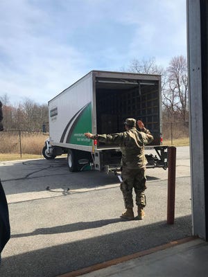 A member of the National Guard helps direct a truck to drop off supplies in Dutchess County as seen on Tuesday, March 18, 2020.