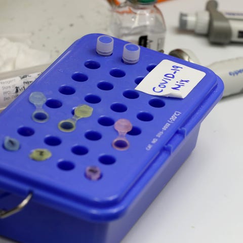 Small vials sit in a holder while other work is do