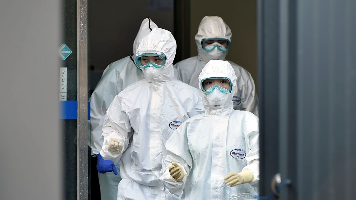 Medical staff members arrive for a duty shift at Dongsan Hospital in Daegu, South Korea, Wednesday, March 18, 2020. For most people, the new coronavirus causes only mild or moderate symptoms, such as fever and cough. For some, especially older adults and people with existing health problems, it can cause more severe illness, including pneumonia. (Lee Moo-ryul/Newsis via AP) ORG XMIT: SEL801