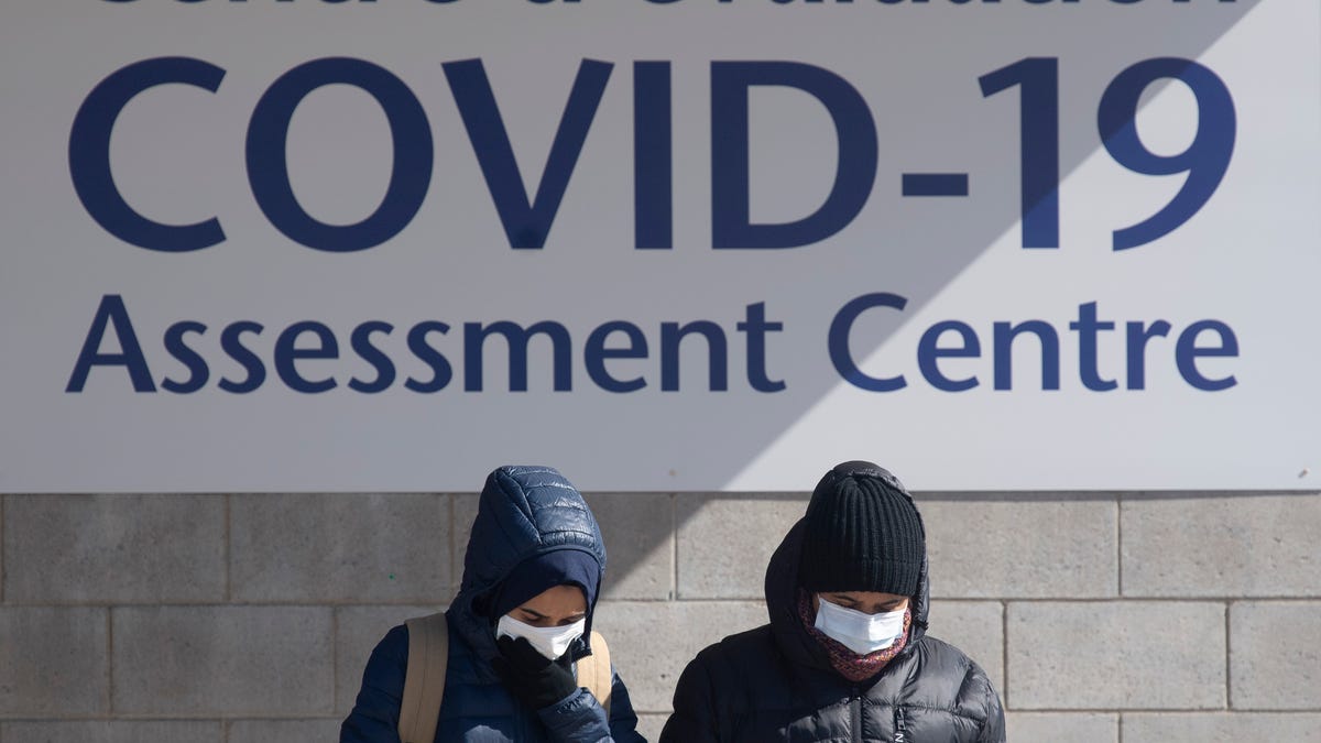 People leave a COVID-19 assessment center, Saturday, March 14, 2020 in Ottawa. For most people, the new coronavirus causes only mild or moderate symptoms. For some it can cause more severe illness, especially in older adults and people with existing health problems.