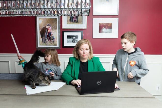 Melissa Joy, president of Pearl Planning, a wealth adviser in Dexter, is splitting working from home and the office. She's pictured with her two children at home, Josie Joy, age 6, and Gus Joy, age 10.