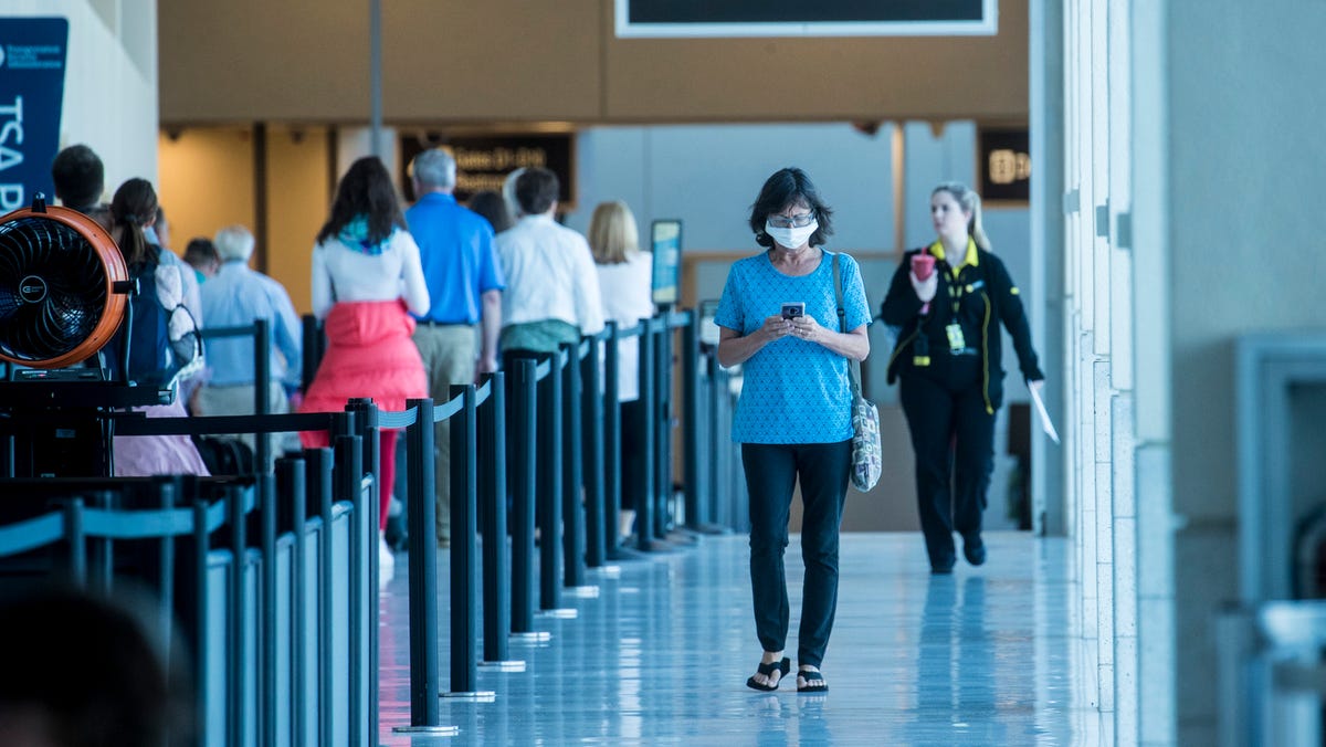 A woman heads out of one of the concourses at Southwest Florida International Airport on Thursday, March 19, 2020. Traffic is down at the airport because of the coronavirus pandemic.
