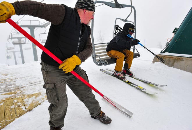 Eric Campbell, a lift operator at Showdown, grooms the offloading area at the top of the lift on March 18, 2020.