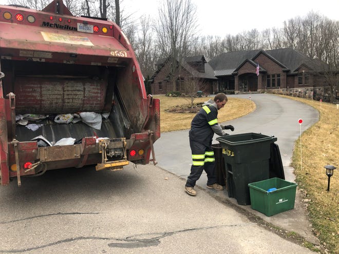 Zach Robinett, GFL sanitation worker, on the job in Milford on March 18, 2020, during the age of coronavirus.