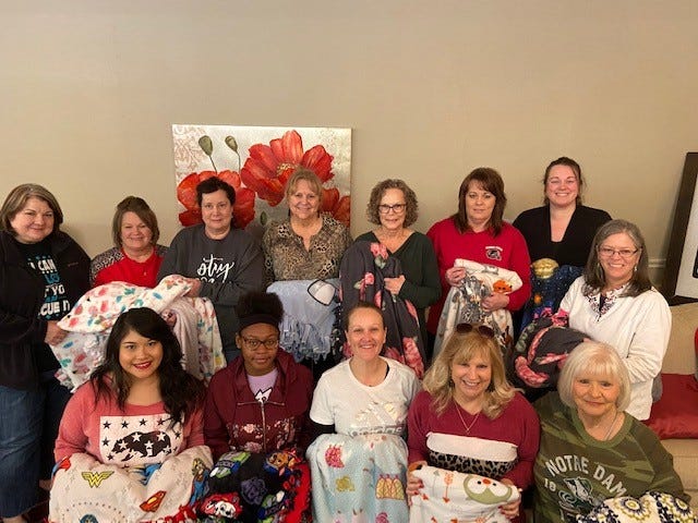 Senior Junior Forum members enjoyed spending  time together  making blankets for Patsy’s House. Bottom row, left to right: Marianne Dowdy, Adrianna West, Trisha Hoover, Ladell Schmalzried, Connie Joyce. Top row, left to right: Lisa Riley, Pam Reese, Debra Burnett, Colleen James, Melody Jennings, Sue Ann Ozment, Ashley Parvin-Sauls and Vicky Payne.