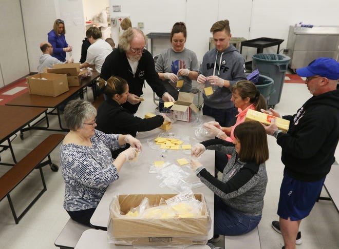 Volunteers assemble sandwich contents at Zanesville Middle School on Thursday. Zanesville City Schools will distribute food at their schools from 10 a.m. to 1 p.m. today. In addition, food will be distributed at Zanesville Metropolitan Housing locations, and Veterans Park at the corner of Ontario St. and Moxahala Avenue. The district is encouraging drive-up pick-up to minimize contact. There will also be a box available to for students to drop off completed work.