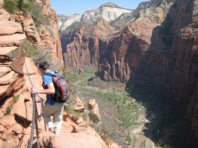 A hiker climbs down from the Angels Landing summit.