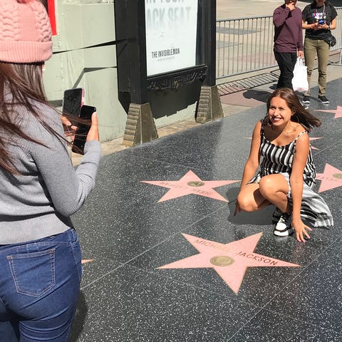A woman poses in front of the late Michael Jackson
