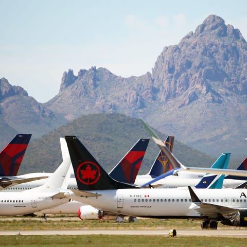 Three Delta Air Lines passenger jets are parked am
