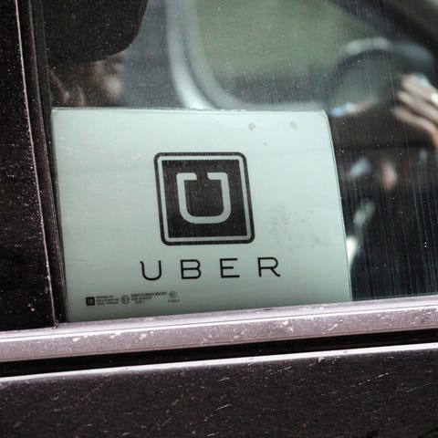 An Uber car drives through LaGuardia Airport in Ne
