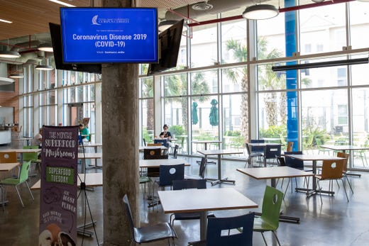 A few students sit in a nearly empty dining hall at Texas A&M University-Corpus Christi on Friday, March 20, 2020, as spring break was extended due to COVID-19.