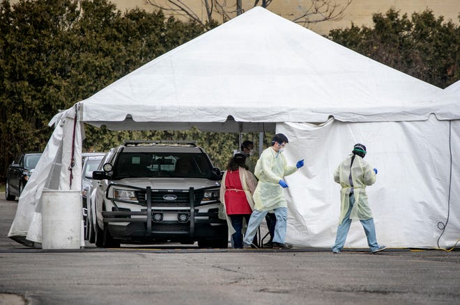 Wayne State medical professionals participate in the Detroit Regional COVID-19 Drive Thru Testing Program by testing first responders Friday, March, 20, 2020 for the COVID-19 virus. Wayne State with the help of the DPD funneled traffic one way down Brush Street from the I-75 service drive to tents set up in a lot at 2900 Brush Street in Detroit.